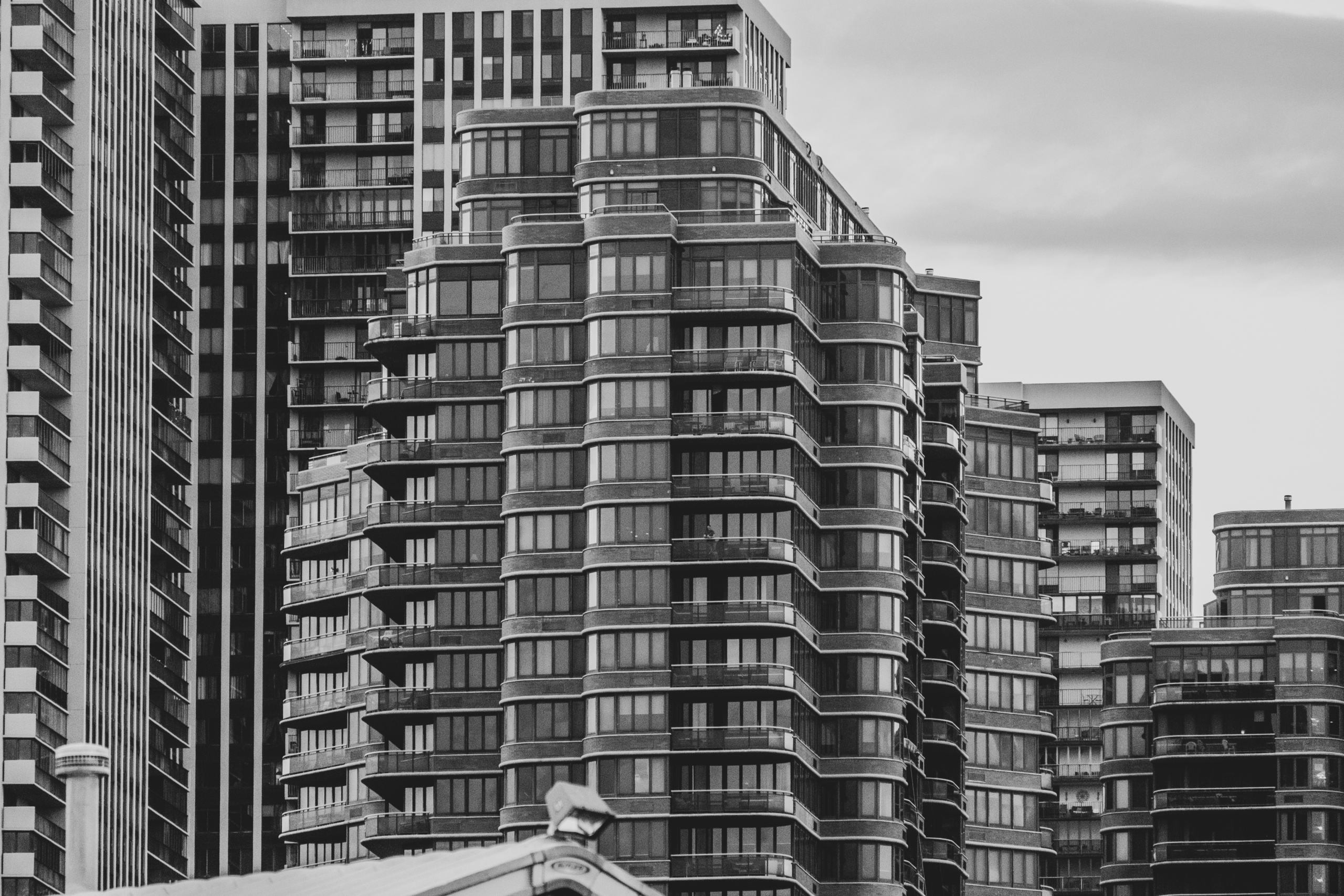 A grayscale image capturing modern high-rise buildings showcasing urban architecture.